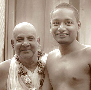 Sivananda pulls Swami Venkatesananda close to him in firm embrace