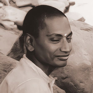 Swami Venkatesananda sits by the Ganges to listen to Swami Sivananda playing the veena.