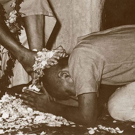 With head bowed after finishing a pada-puga to this Guru, Swami Sivananda. 