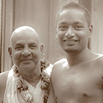 Sivananda holding Swami Venkatesananda close to him.